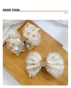 Detail of mesh hair clips with sequin heart and mouse silhouette on wooden tray