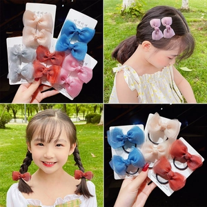 Detailed view of layered mesh bow hair clips and hair ties for girls in multiple colors