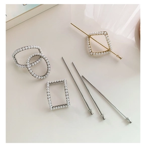 Detail of geometric pearl hair pins in gold and silver finish for elegant hair styling