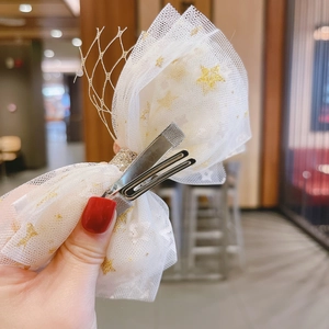 Handmade white mesh hair clip for girls with gold star patterns and metallic bow details