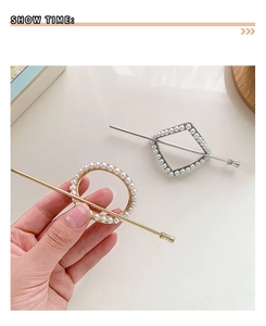 Detail of minimalist gold and silver metal hairpins with inlaid pearls for hair buns