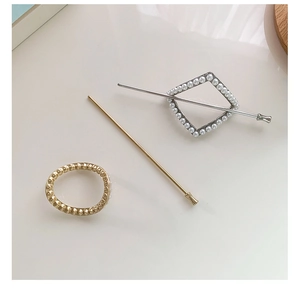 Close-up of elegant pearl hair pins and minimalist gold hair accessories for women