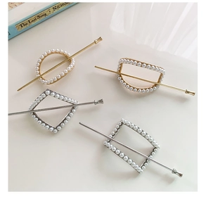 Detail view of geometric pearl hairpins in gold and silver finish with elegant bead inlay