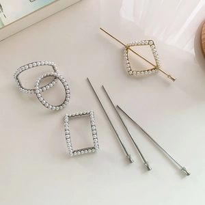 Minimalist pearl hair pin set with geometric metal shapes on a beige background
