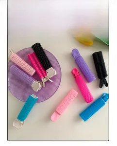 Flat lay of colorful plastic hair root clips with velcro texture on a white surface