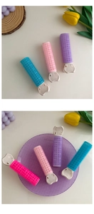 Close-up of colorful hair root clips with velcro rollers in pink, purple and blue