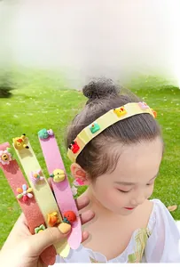 Close-up of kids cartoon hair grippers with glitter finish and cute resin ornaments