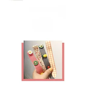 Detail view of cute cartoon hair clips featuring daisy and fruit patterns for kids
