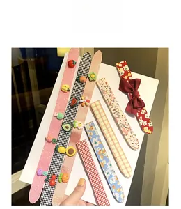 Detailed view of various cute cartoon hairbands featuring sequins, plaid, and floral patterns