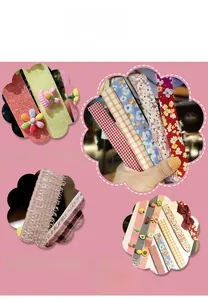 Detail view of assorted cartoon hair clips with floral, plaid patterns and soft 3D animal charms