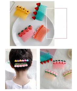 Detailed view of colorful fruit and floral hair combs for girls styling stray hair