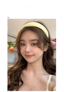 Close-up of a vibrant yellow sponge headband worn by a model for a high top hairstyle