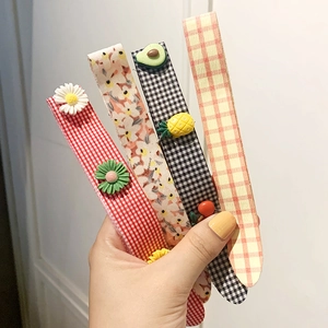 Set of four cute cartoon fabric hair clips with floral and plaid patterns for girls