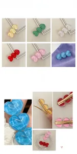 Detail of colorful resin heart hair clips with golden non-slip metal duckbill grip