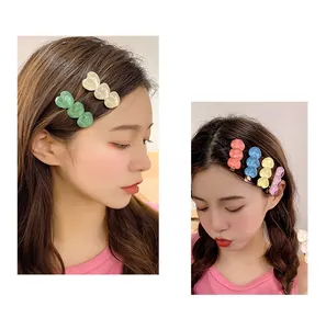 Sweet candy-colored resin heart hair clips shown on model for stylish daily wear