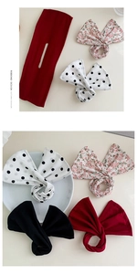 Detail of floral fabric deft bun makers in red, black, polka dot, and pink patterns