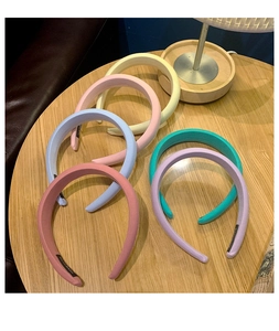 Detailed view of handmade wide sponge headbands in six vibrant macaron candy colors