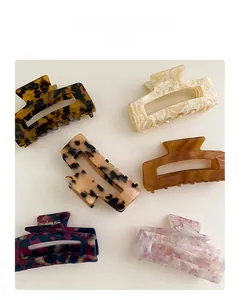 Detail of square hollow acetate hair claws in various floral and marble patterns