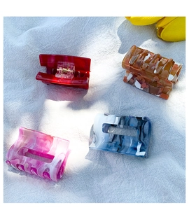 Detailed set of four tortoiseshell acetate hair claws in assorted marble and solid colors