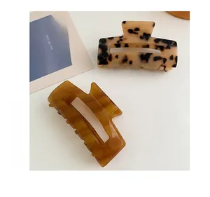 Detail of square hollow hair claws in classic tortoiseshell and amber acetate patterns