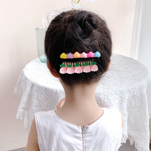 Girl's hair comb set with heart and tulip accessories shown on child's hairstyle