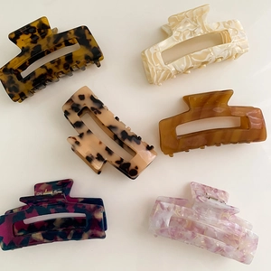 Set of 6 large acetate hair claw clips with floral and marble patterns on white base