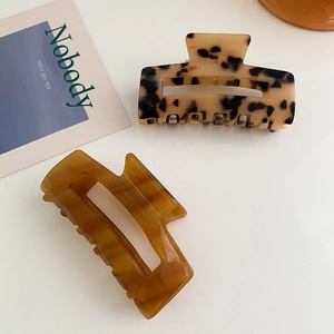 Set of two large hollow rectangular acetate hair claws in leopard and amber patterns