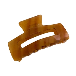 Large square hollow hair claw clip with amber marble texture and acetate finish
