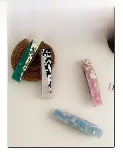 Detailed view of acetic acid spring hair clips with marble texture in various colors