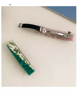 Detail of green marble floral hair clip with durable silver metal spring clasp and anti-slip pad