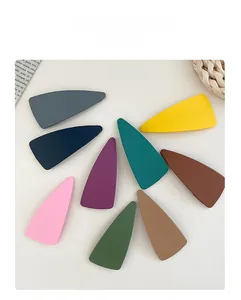 Flat lay of nine large triangle BB hair clips in matte Morandi candy colors