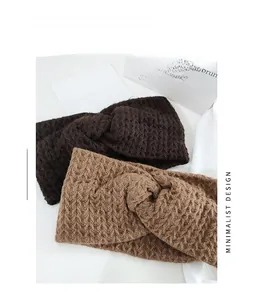 Detailed close-up of knitted twist headbands in dark brown and camel waffled fabric