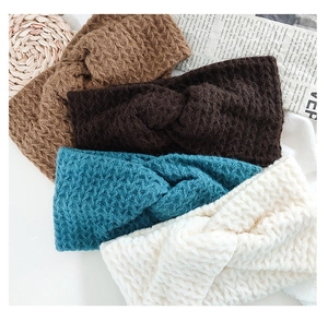 Detailed macro view of four knitted twisted headbands in coffee, blue, and beige tones