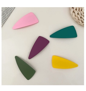 Matte Morandi tone triangle hair clips in five colors on a minimalist background