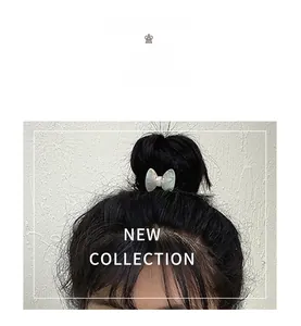 Detailed macro view of acetate bow hair tie with pearlescent shell texture and glossy finish