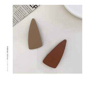 Close-up of matte acrylic triangle hair clips in coffee and dark brown colors