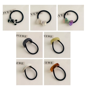 Detail view of acetate bow and geometric hair ties in various marble textures and colors
