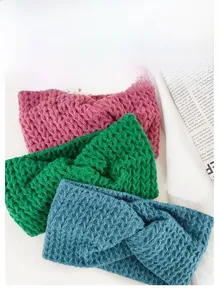 Detailed view of three-piece knitted headbands with honeycomb texture and knot design