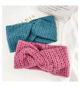Detail of twisted knitted headbands in teal and rose pink with chunky crochet texture