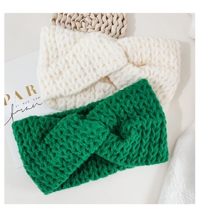 Detail of knitted twist headbands in cream white and bright green with ribbed texture