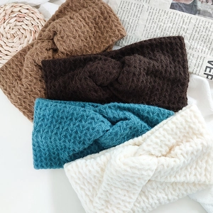 Set of four knitted twist headbands in brown, blue, and cream for autumn winter hair styling