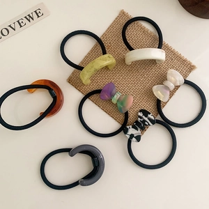 Elegant acetate bow and curved hair ties in diverse marble textures and amber colors