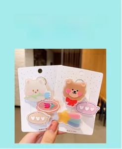 Close-up of girls' cartoon hair clips featuring cute bears and colorful tulips