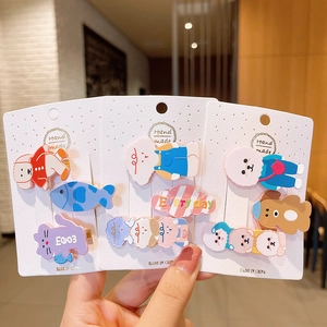 Close-up of cute cartoon hair clips set with puppy and cat shapes on handmade cards