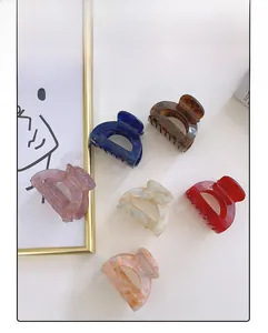 Detailed view of six vintage acetate hair claws in various marble and tortoiseshell patterns