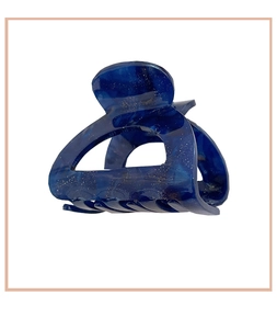 Close-up of blue marble acetate hair claw clip with golden glitter and hollow design