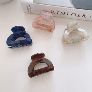 Retro acetate hair claws in four colors including marble and tortoiseshell patterns