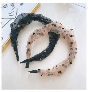 Close-up of pleated bunny ear chiffon headbands with polka dots and twisted mesh texture