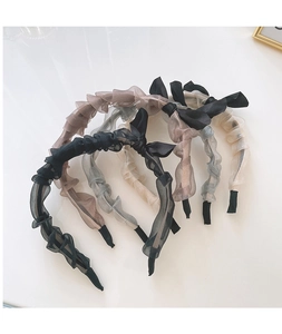 Detailed texture of ruffled organza headbands with elegant bows in Morandi colors