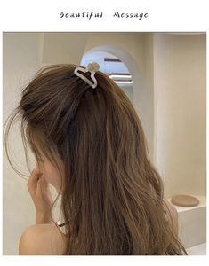 Chic beige marble acetate hair claw clip styled on wavy hair for a trendy look